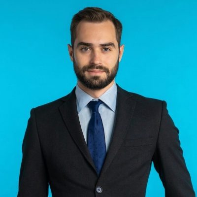 close-up-portrait-of-young-successful-confident-businessman-with-beard-isolated-on-blue-studio_t20_XxJbn9-e1595906672420.jpg